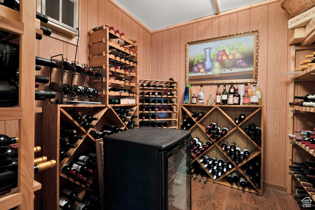 Wine room with wooden walls and wood finished floors