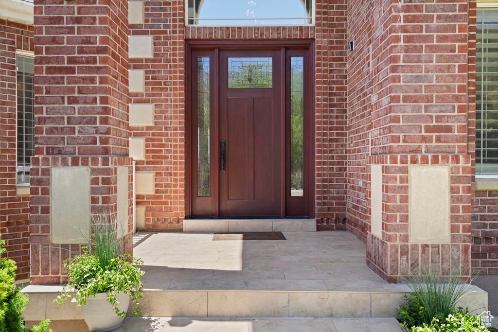 Doorway to property with brick siding