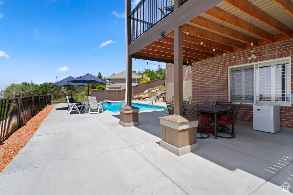 Fenced backyard featuring outdoor dining area and a patio