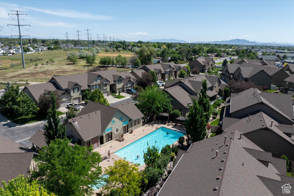 Aerial view of residential area with a pool area and a mountain backdrop