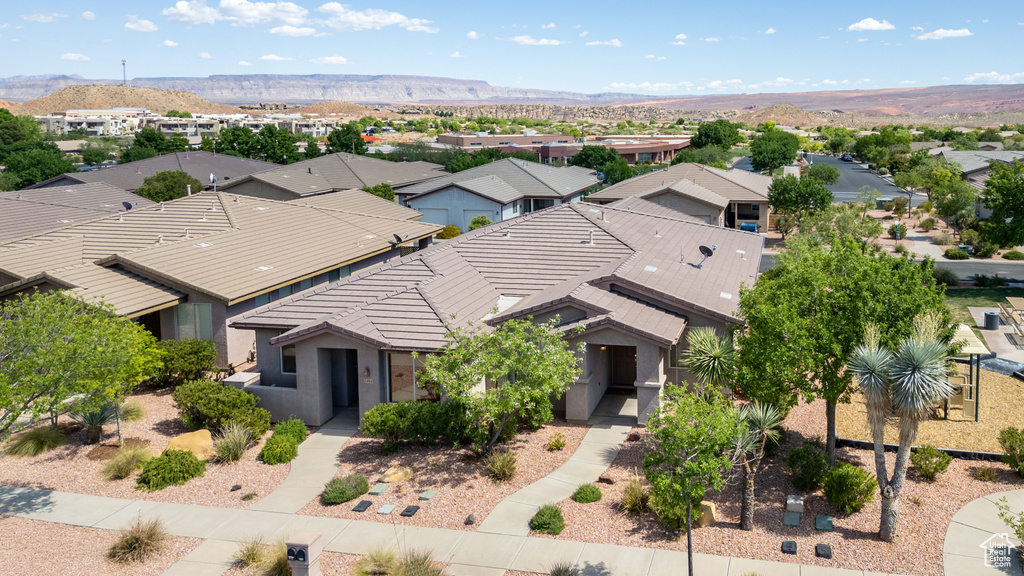 Aerial perspective of suburban area featuring a mountainous background