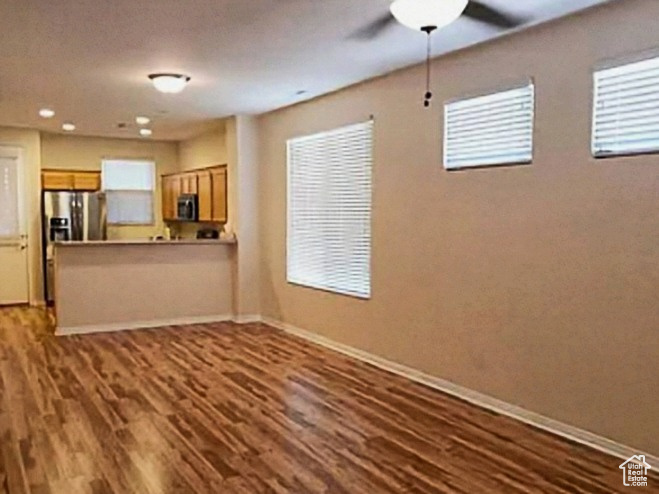 Unfurnished living room featuring baseboards, wood finished floors, ceiling fan, and recessed lighting