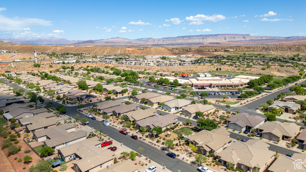 Aerial overview of property's location featuring a mountain backdrop and nearby suburban area