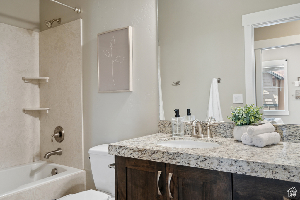 Full bath with shower / tub combination, vanity, and toilet