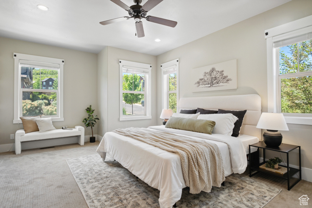 Carpeted bedroom featuring baseboards, recessed lighting, and ceiling fan