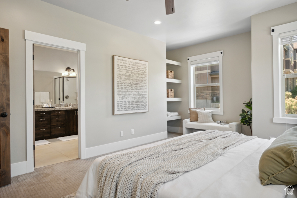 Bedroom featuring light colored carpet, baseboards, ensuite bathroom, ceiling fan, and recessed lighting