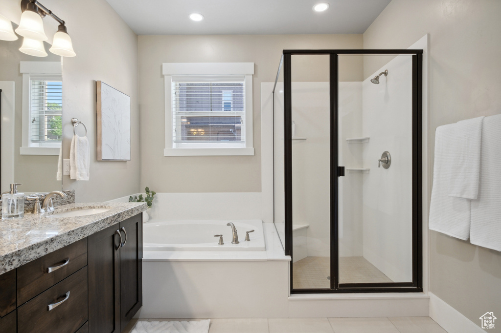 Bathroom featuring vanity, a shower stall, a garden tub, tile patterned flooring, and recessed lighting