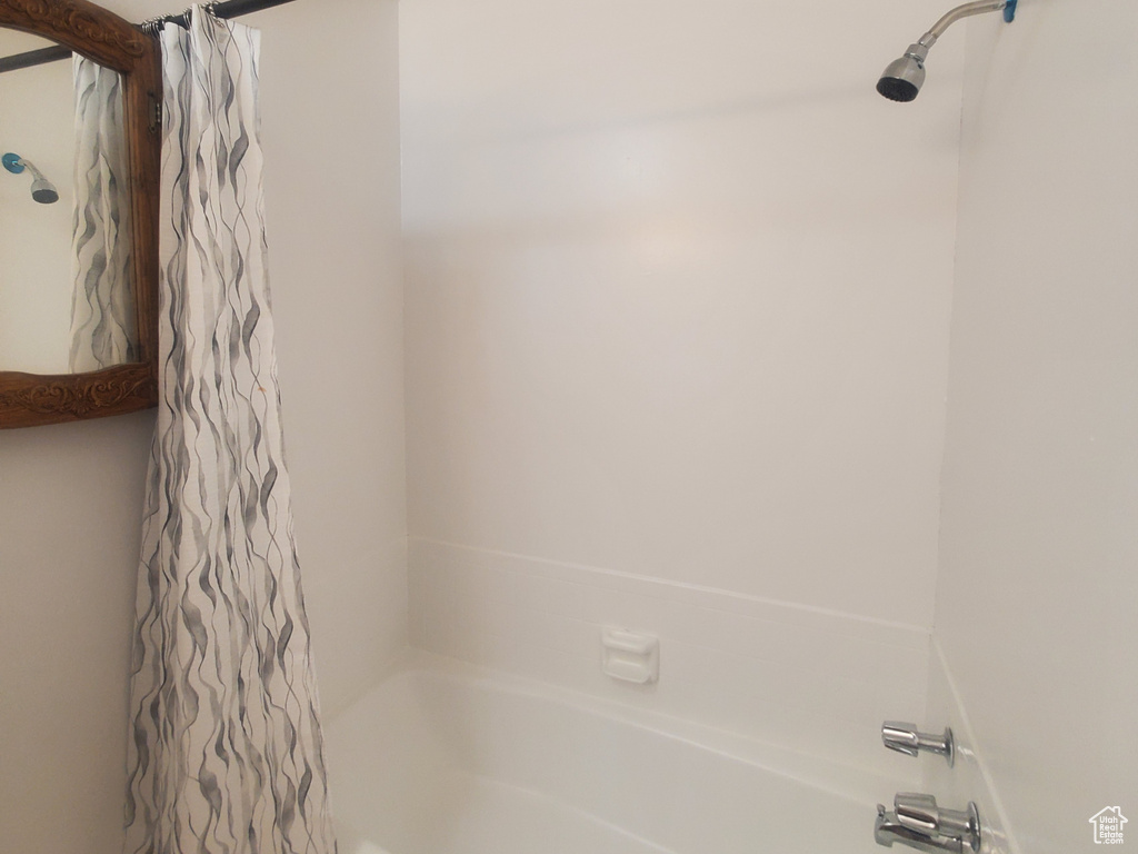 Full bath with shower / bath combo with shower curtain and tile patterned flooring