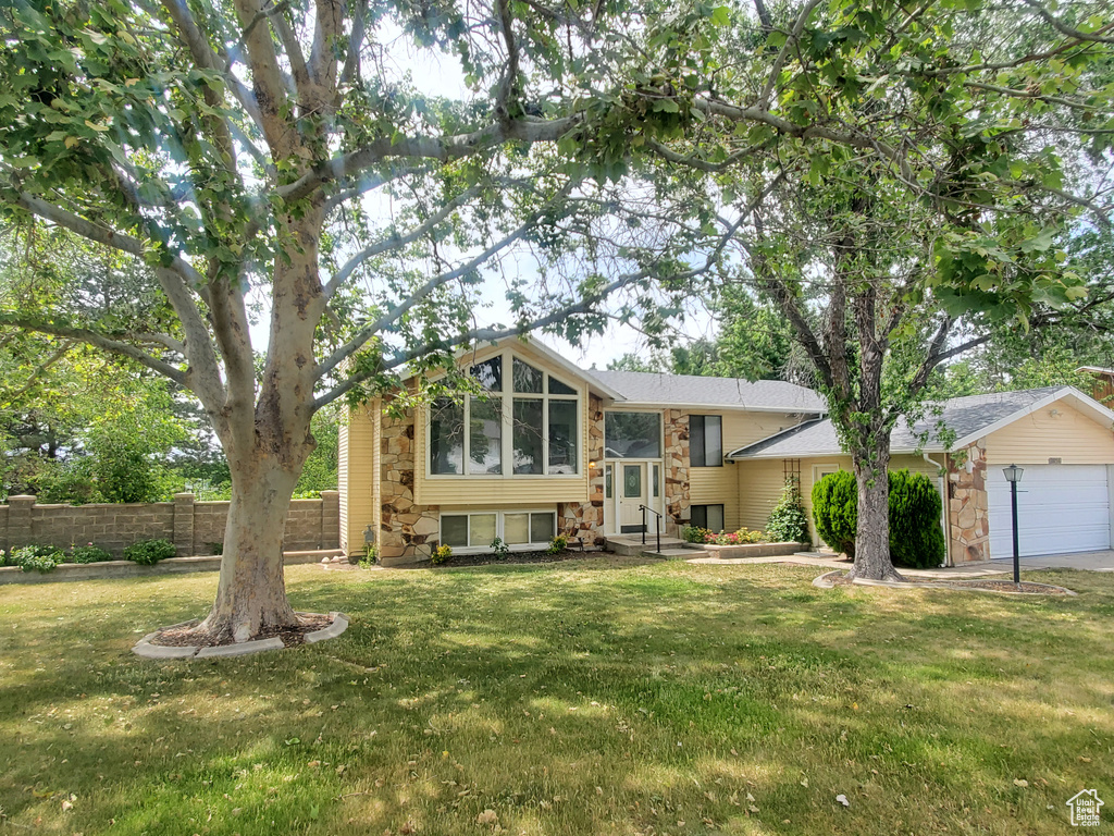 View of front of home featuring stone siding and an attached garage