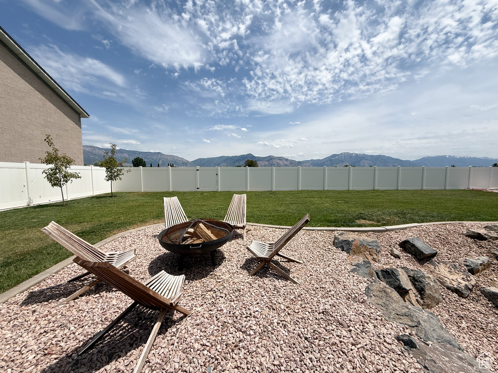 View of yard featuring an outdoor fire pit and a mountain view
