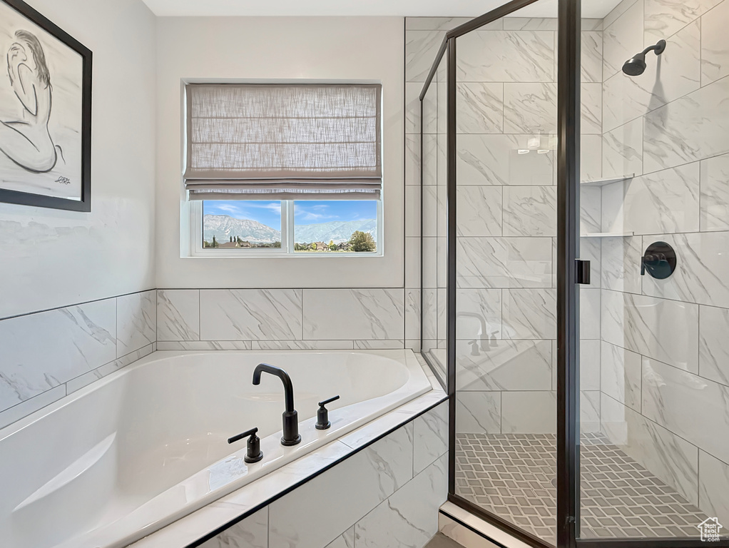 Bathroom featuring a garden tub and a stall shower