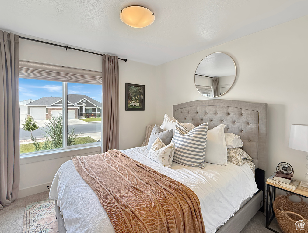 Bedroom with carpet, multiple windows, and baseboards