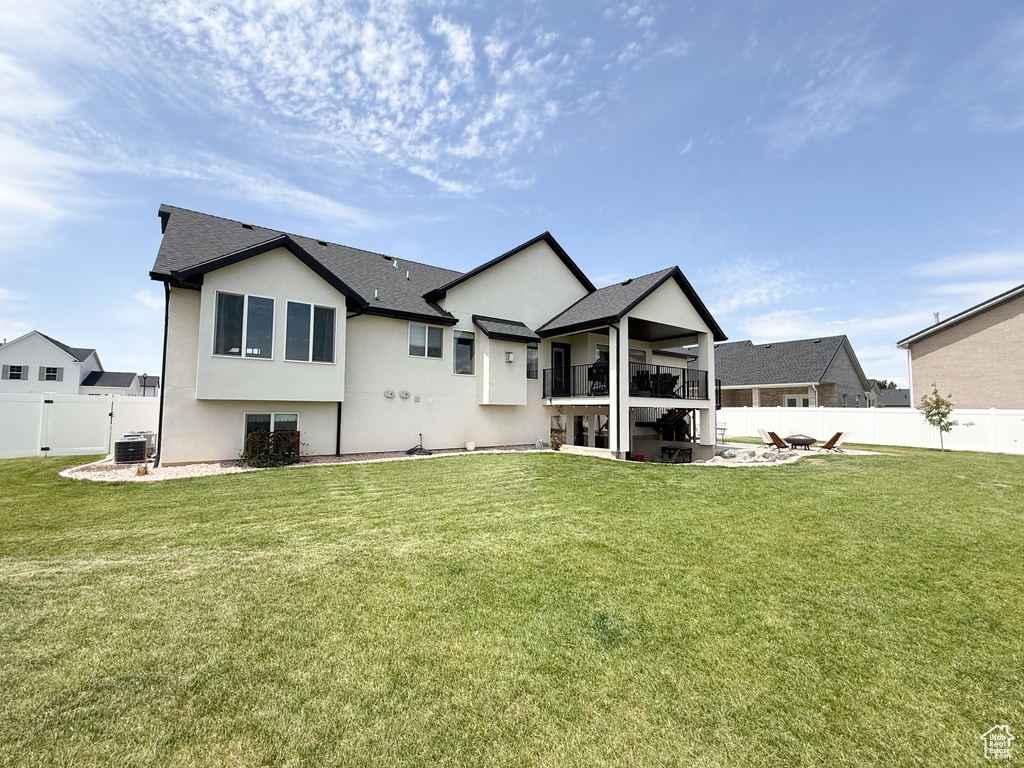 Rear view of property with a balcony, stucco siding, a patio, central AC, and roof with shingles