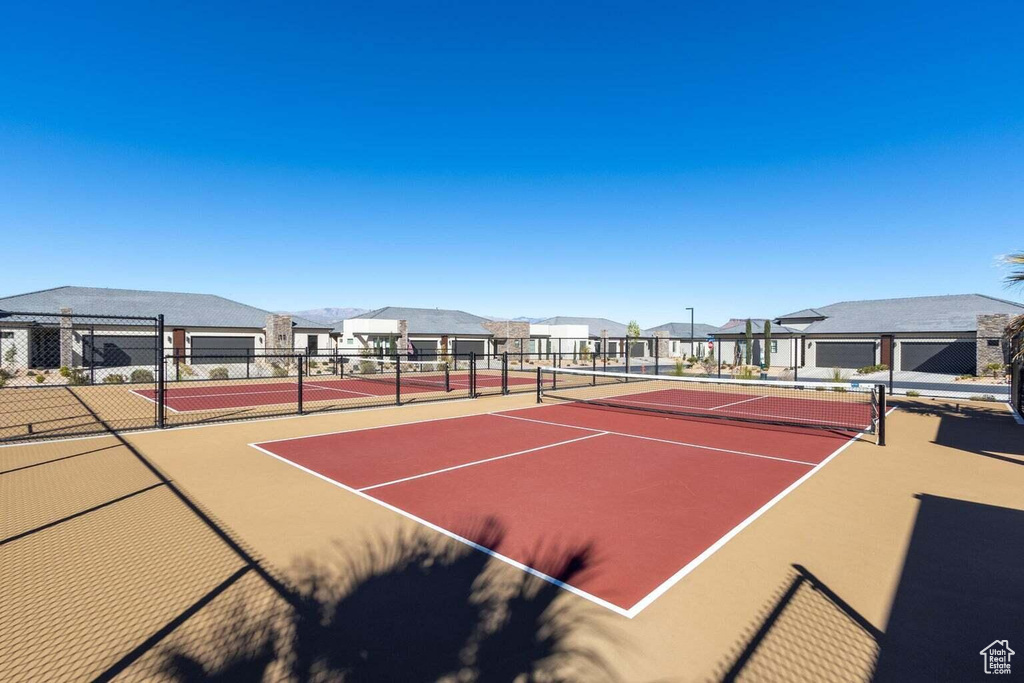 View of tennis court with community basketball court and a residential view