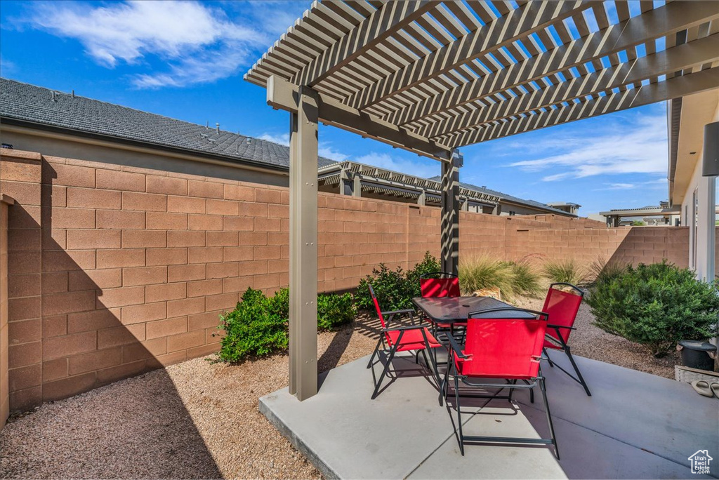 Fenced backyard featuring outdoor dining space, a pergola, and a patio area