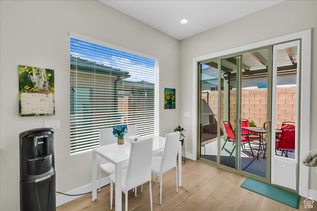 Dining room with light wood-style flooring, baseboards, and recessed lighting
