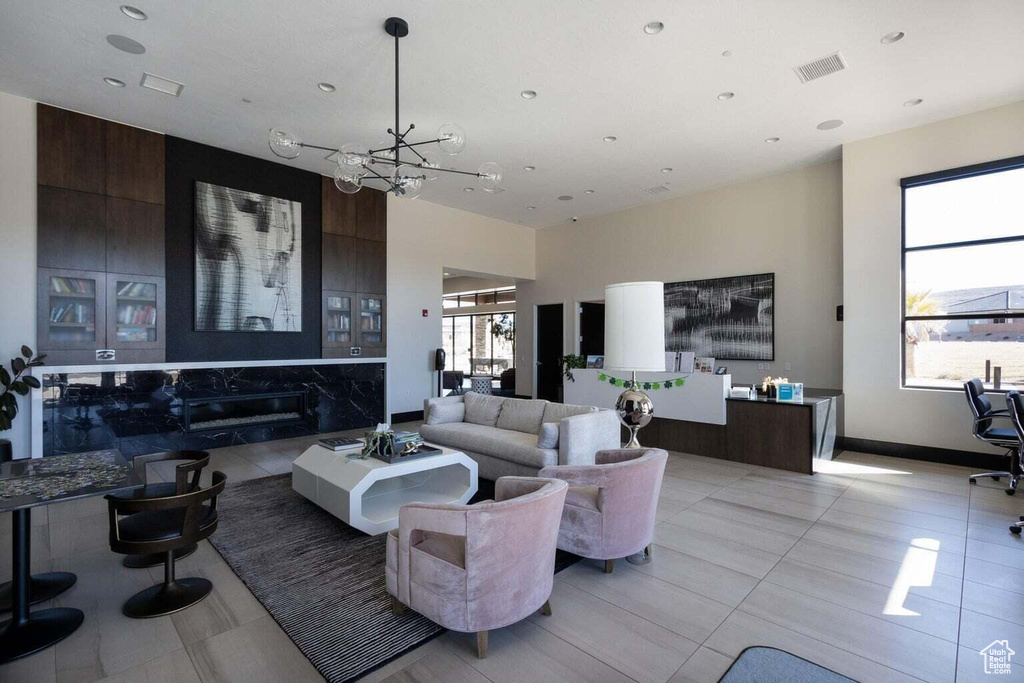 Living room with a chandelier, recessed lighting, and light tile patterned floors