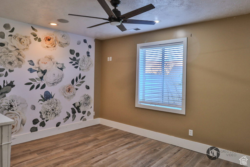 Unfurnished room featuring baseboards, wood finished floors, ceiling fan, and recessed lighting
