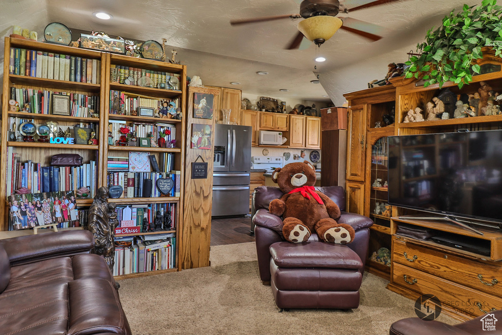 Living area featuring a ceiling fan, carpet flooring, and recessed lighting