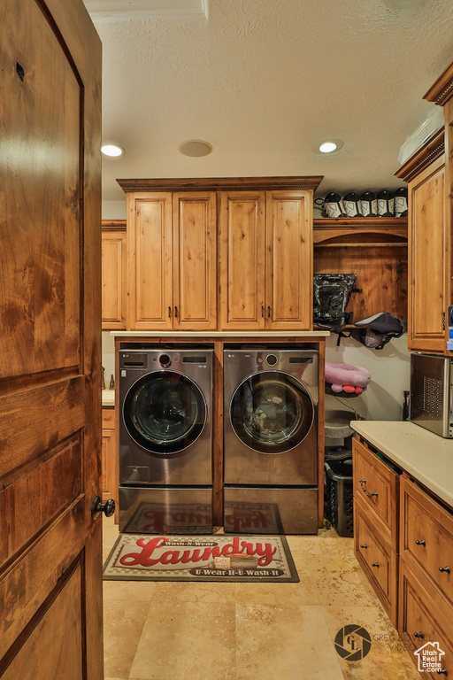 Washroom with cabinet space, washing machine and clothes dryer, and recessed lighting