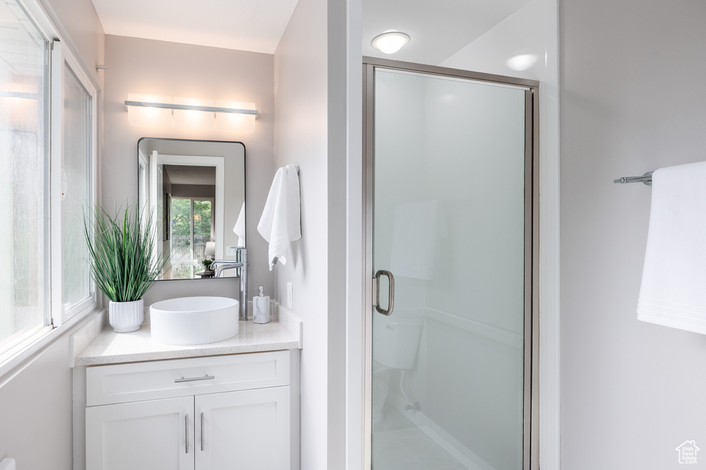 Full bath featuring vanity and a stall shower