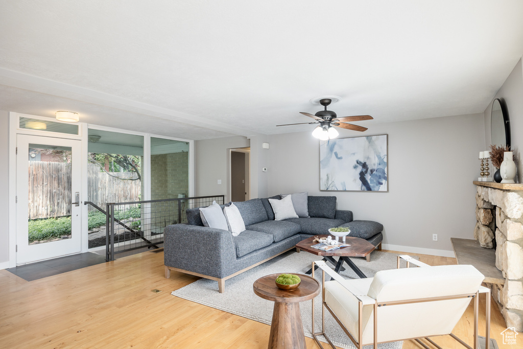 Living room featuring baseboards, wood finished floors, and ceiling fan