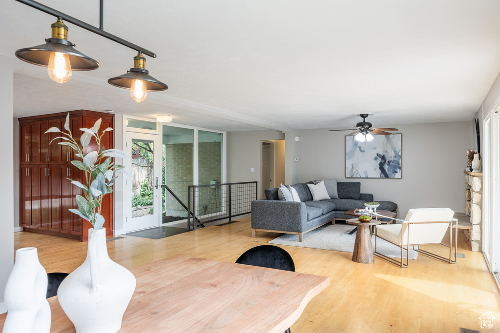 Living area featuring wood finished floors, plenty of natural light, and a ceiling fan