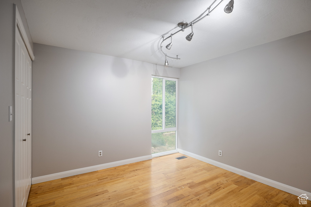 Empty room with wood finished floors and baseboards