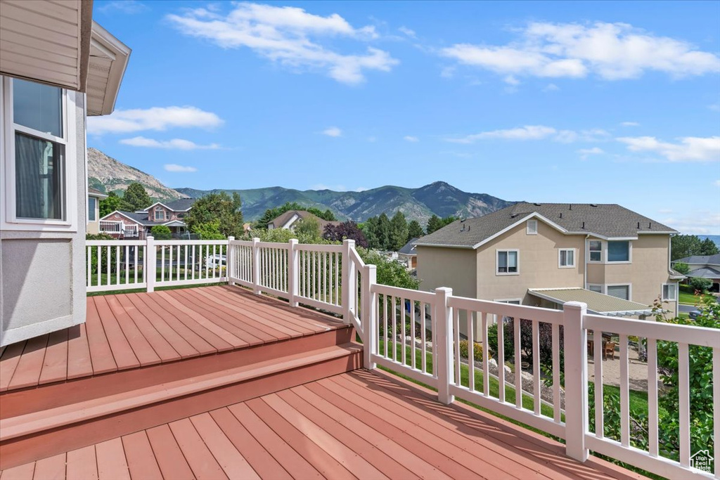 Wooden deck featuring a mountain view and a residential view