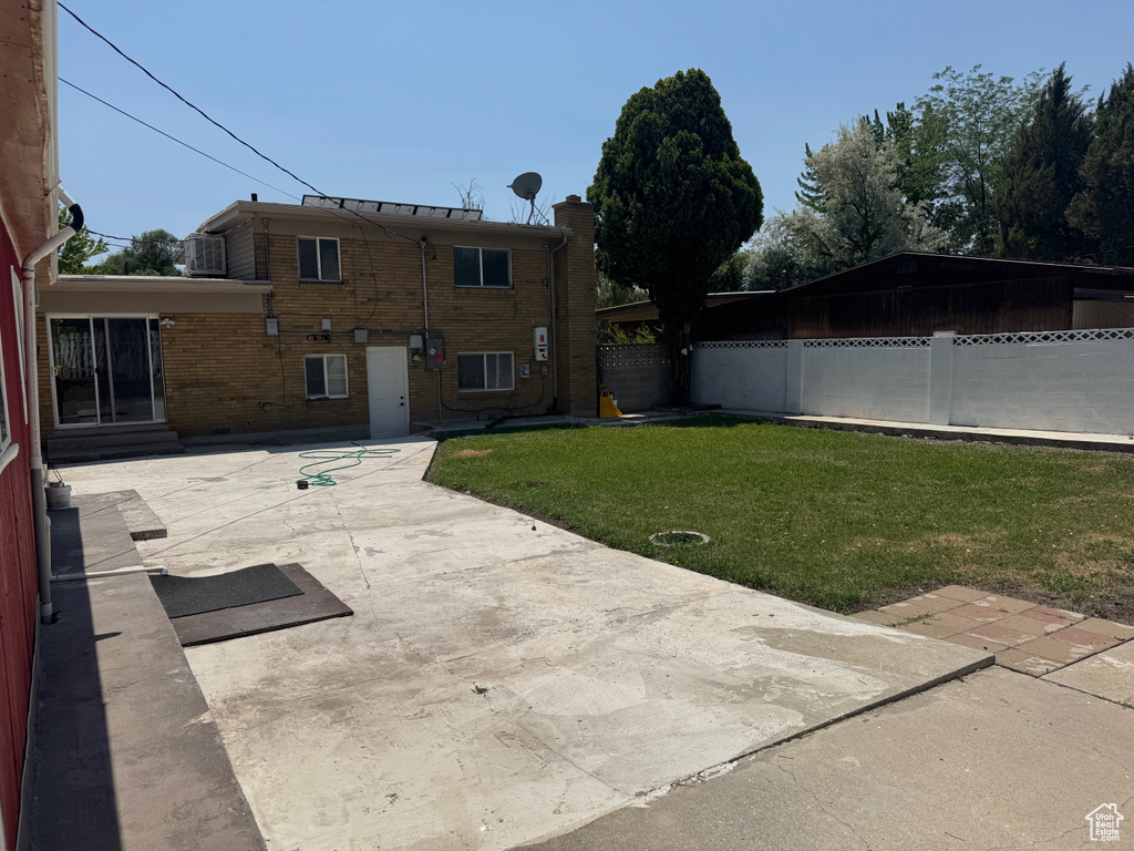 Rear view of house with a patio area and brick siding
