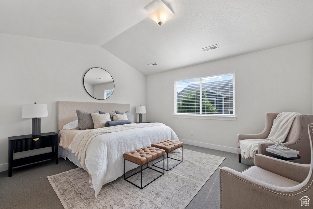 Bedroom with carpet flooring, lofted ceiling, and baseboards