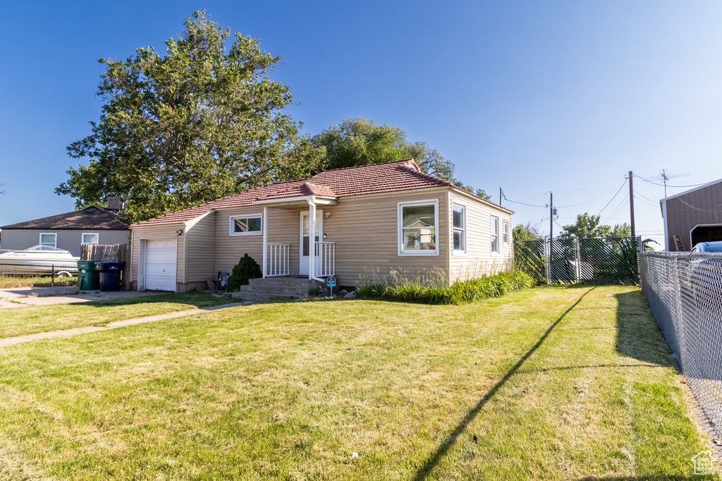 View of front of property featuring an attached garage and driveway