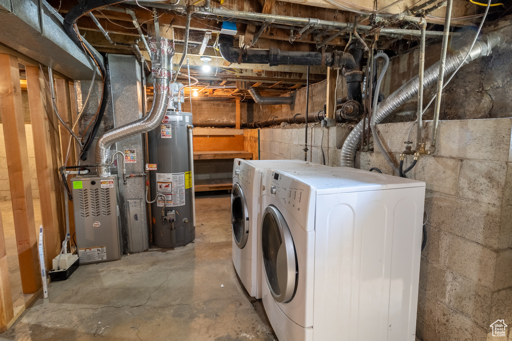 Unfinished basement featuring gas water heater and washer and dryer