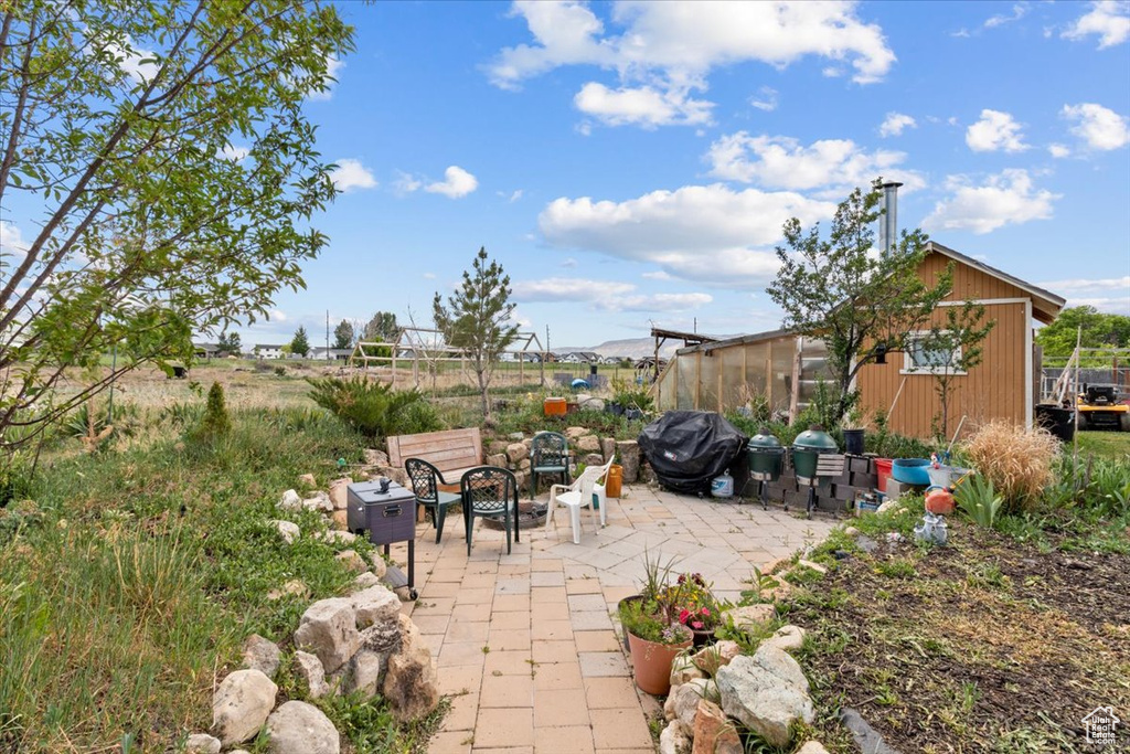 View of patio / terrace featuring an outdoor fire pit and a grill