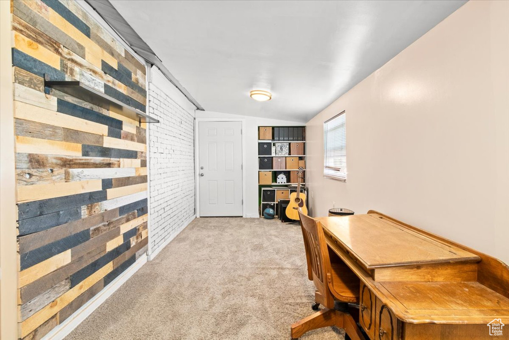 Carpeted office with brick wall