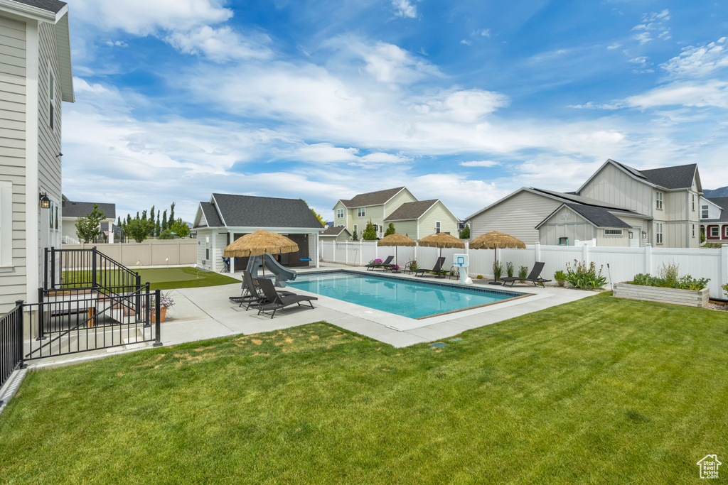 View of pool featuring a residential view, a patio area, an outdoor structure, and an exterior structure