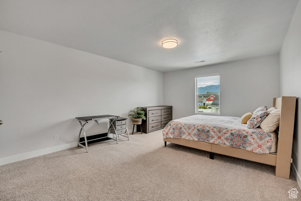 Carpeted bedroom featuring baseboards