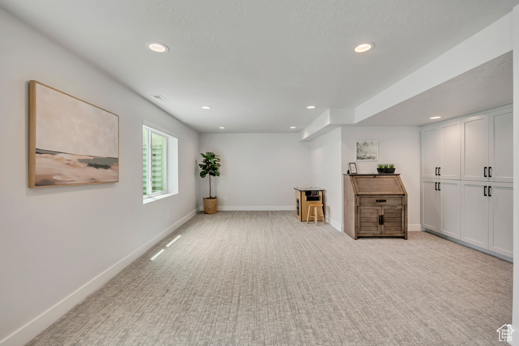 Sitting room with recessed lighting, light carpet, and baseboards