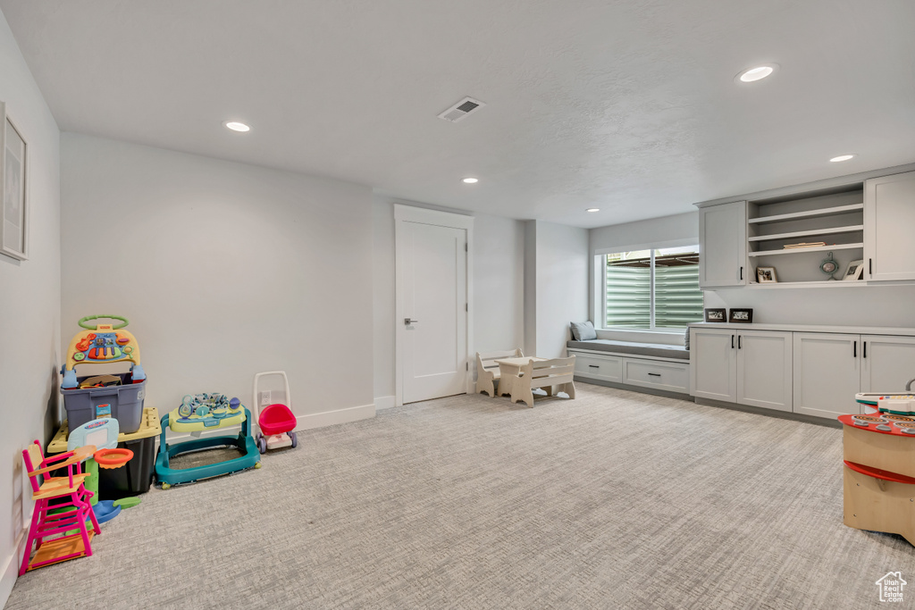 Rec room featuring recessed lighting, light carpet, and baseboards