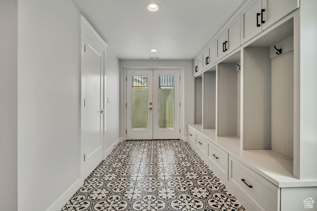 Mudroom with baseboards, french doors, and recessed lighting