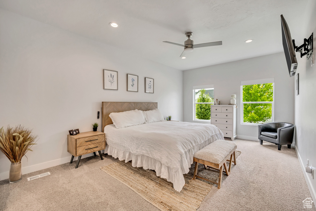 Bedroom with light carpet, baseboards, recessed lighting, and ceiling fan