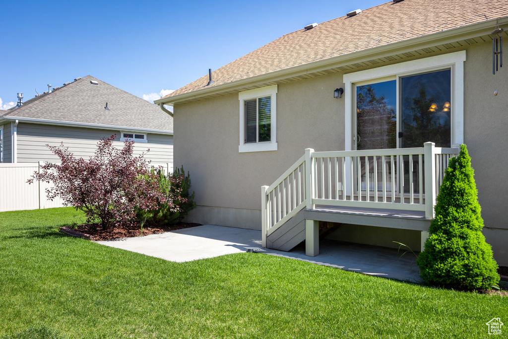 Rear view of property featuring stucco siding and roof with shingles
