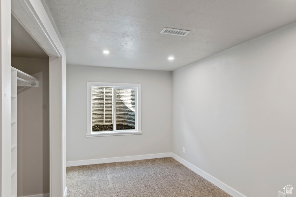 Unfurnished bedroom featuring carpet floors, baseboards, and recessed lighting