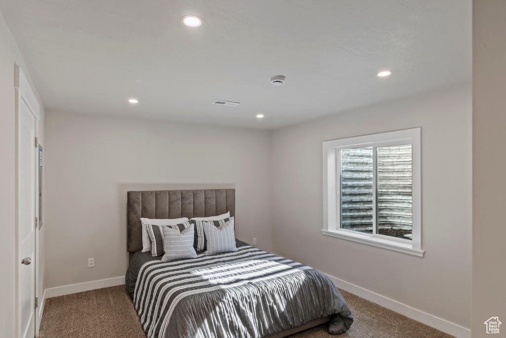 Bedroom with carpet, baseboards, and recessed lighting