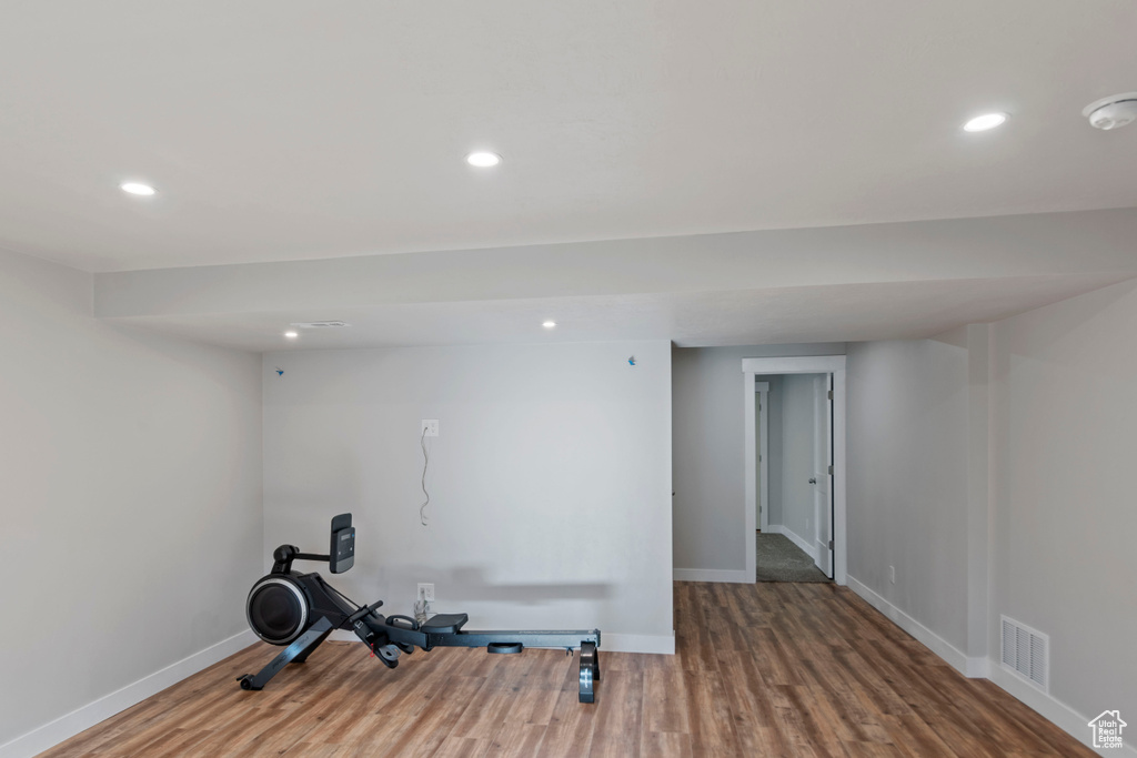 Workout room with wood finished floors, recessed lighting, and baseboards