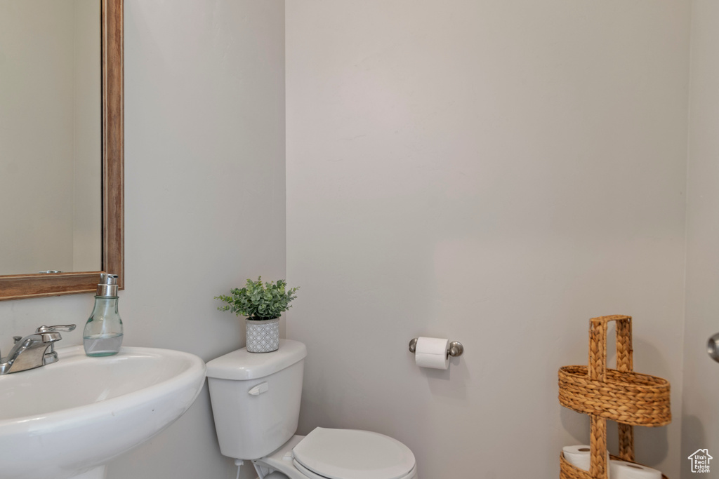Half bathroom featuring a sink and toilet