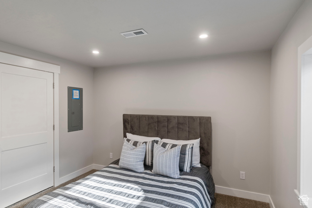 Bedroom featuring electric panel, baseboards, recessed lighting, and carpet floors