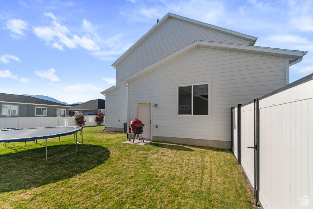Rear view of house with a trampoline