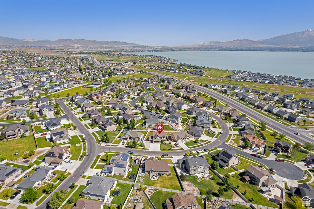 Aerial overview of property's location with a water and mountain view and nearby suburban area