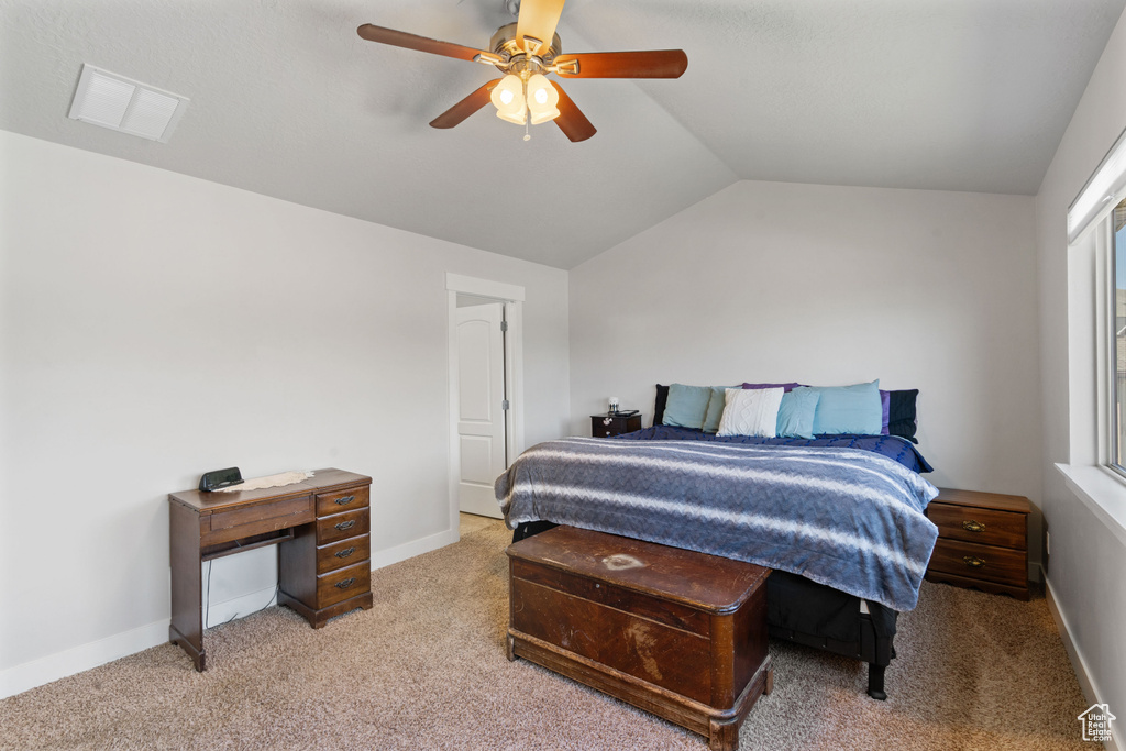 Bedroom featuring carpet floors, vaulted ceiling, ceiling fan, and baseboards